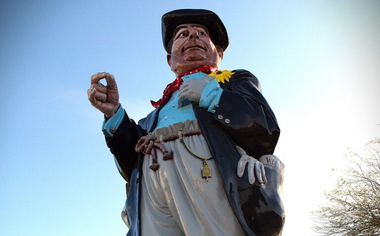 Hobo Joe, a 25-foot fiberglass statue and beloved Buckeye landmark, waves to traffic downtown. [Elias Weiss]